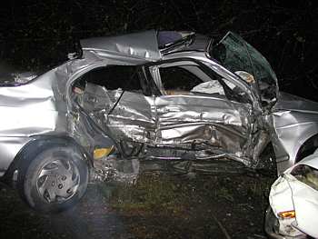 An image of a wrecked silver car that has been t-boned.