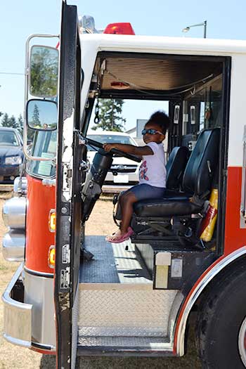 Kyla Peterson sits in SETFA's (Yelm & Rainier Fire Department) ladder truck.