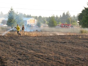 SETFA (Yelm & Rainier) and Department of Natural Resources personnel extinguish hot spots in scorched field in Yelm.