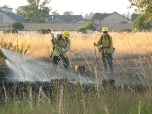 SETFA (Yelm & Rainier) and Department of Natural Resources personnel extinguish hot spots in scorched field in Yelm.