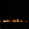 Fire burns a field off of Old McKenna Highway during the 4th of July Holiday weekend.